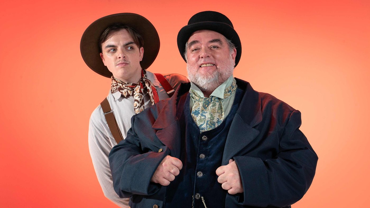 Portrait of the Claimant and Roger against an orange gradient background